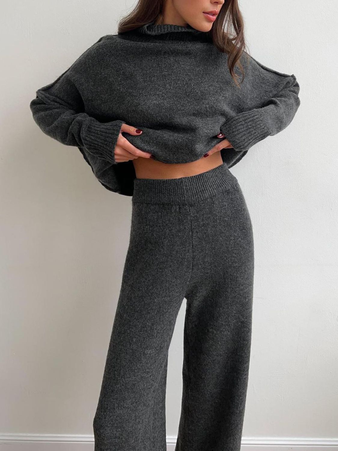 Dark gray acrylic oversized turtleneck lounge set with wide leg pants.