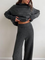 Dark gray acrylic oversized turtleneck lounge set with wide leg pants.