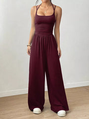 Burgundy ruched wide-leg jumpsuit with spaghetti straps and a comfortable flowy fit.