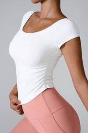 White performance tee with gathered side detail and scoop neck.