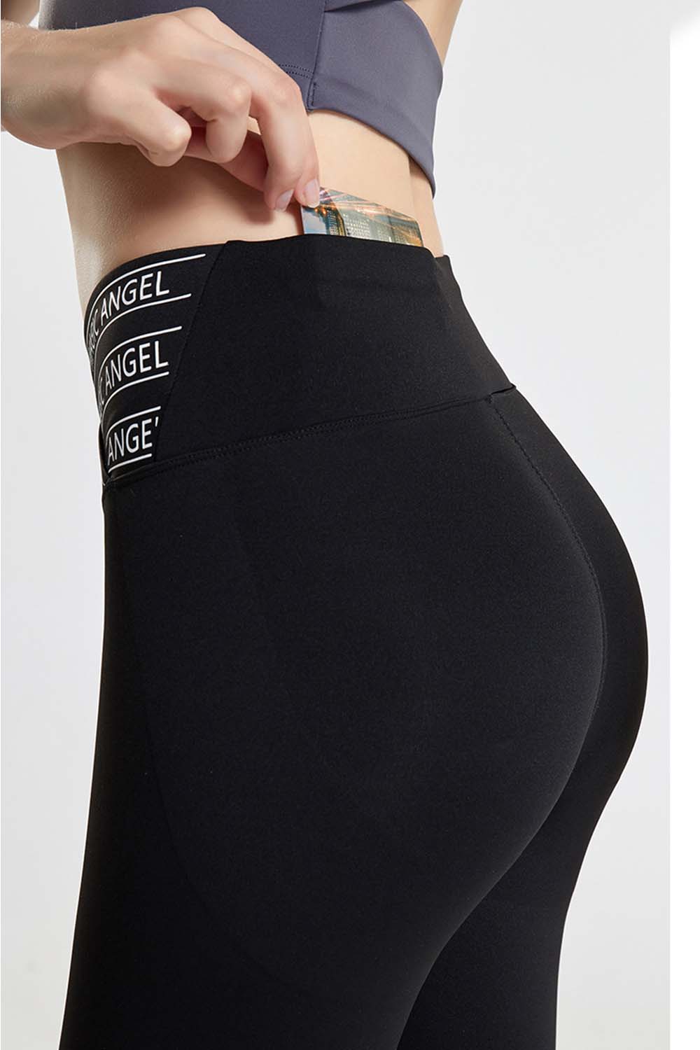 Black active leggings with repeating Angel logo waistband detail.