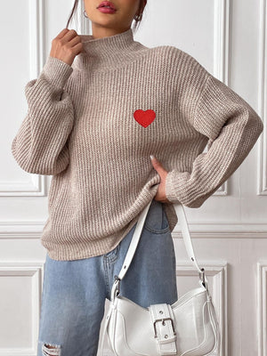 Khaki mock neck knit sweater with red heart appliqué and ribbed texture.