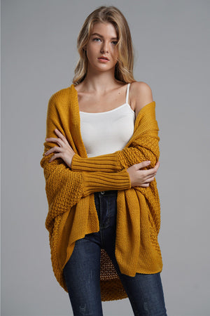 Mustard acrylic cocoon knit sleeve cardigan with textured sleeves and open front.