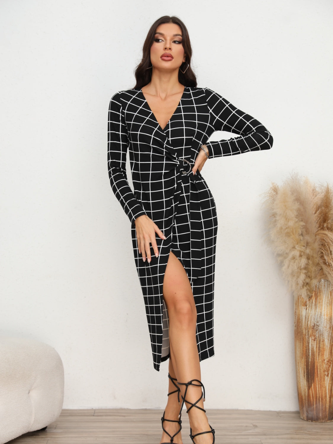 Black grid wrap midi dress with V-neck, long sleeves, and a thigh-high slit.