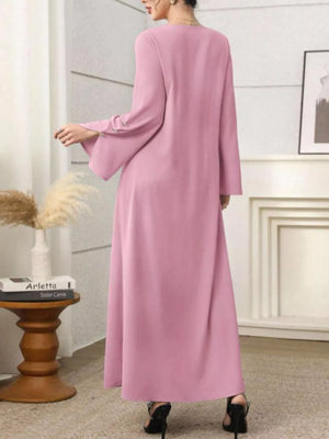 Pink maxi dress with square neckline, long bell sleeves with button detail, and a flowy skirt.