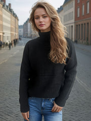 Black relaxed raglan turtleneck knit sweater with ribbed cuffs and hem.