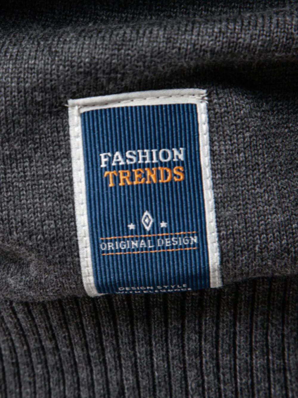 Gray crew neck knit sweater with "Fashion Trends Original Design" label detail
