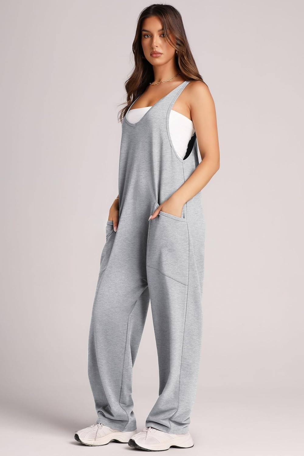 Relaxed fit gray jumpsuit with oversized pockets and a white tank top.