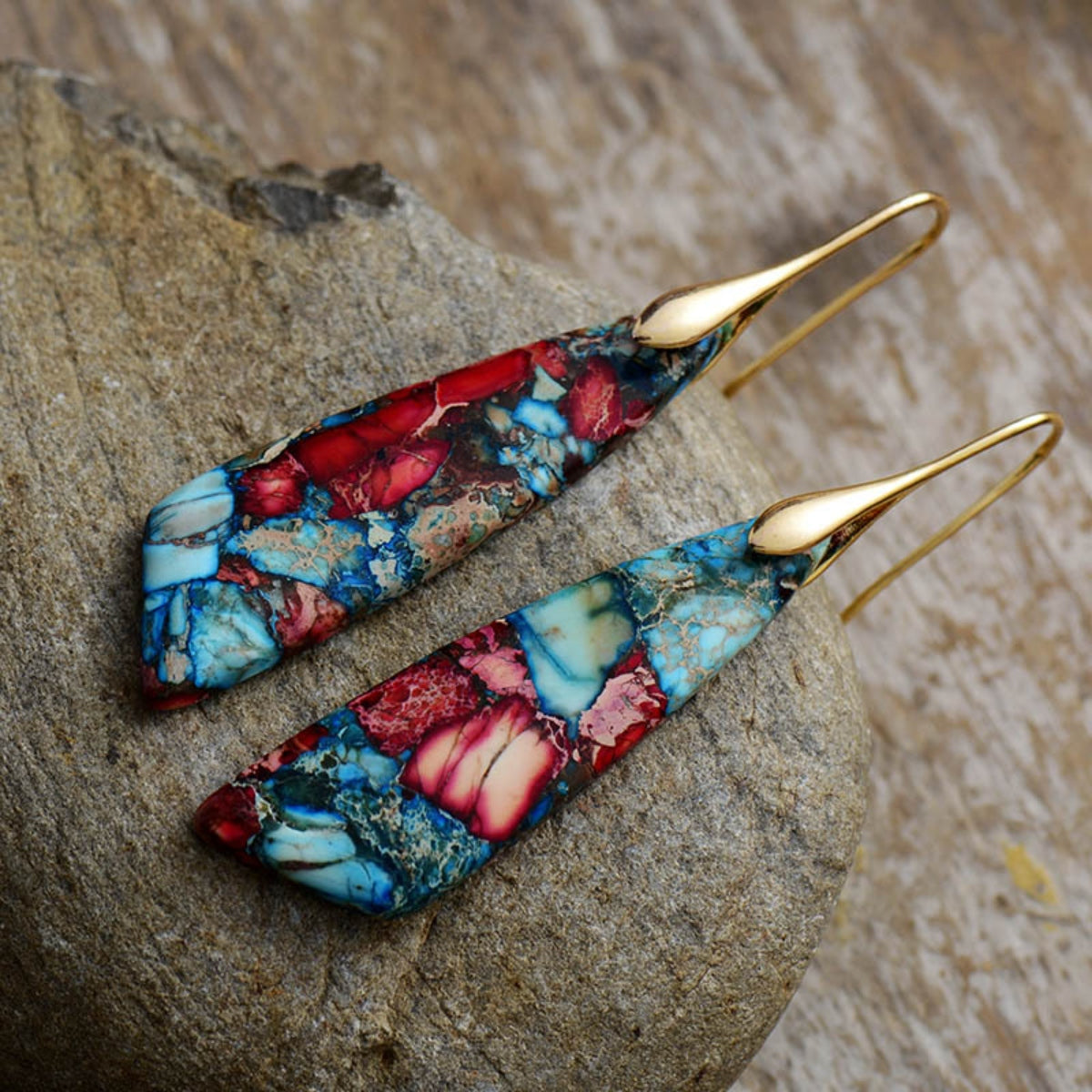 Marbled stone teardrop earrings in red and blue with gold hooks.