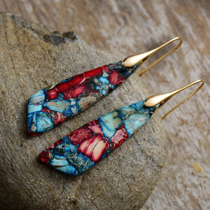 Marbled stone teardrop earrings in red and blue with gold hooks.