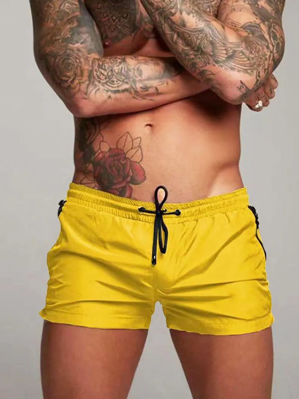 Yellow boardshorts with black side zip pockets and drawstring waist.