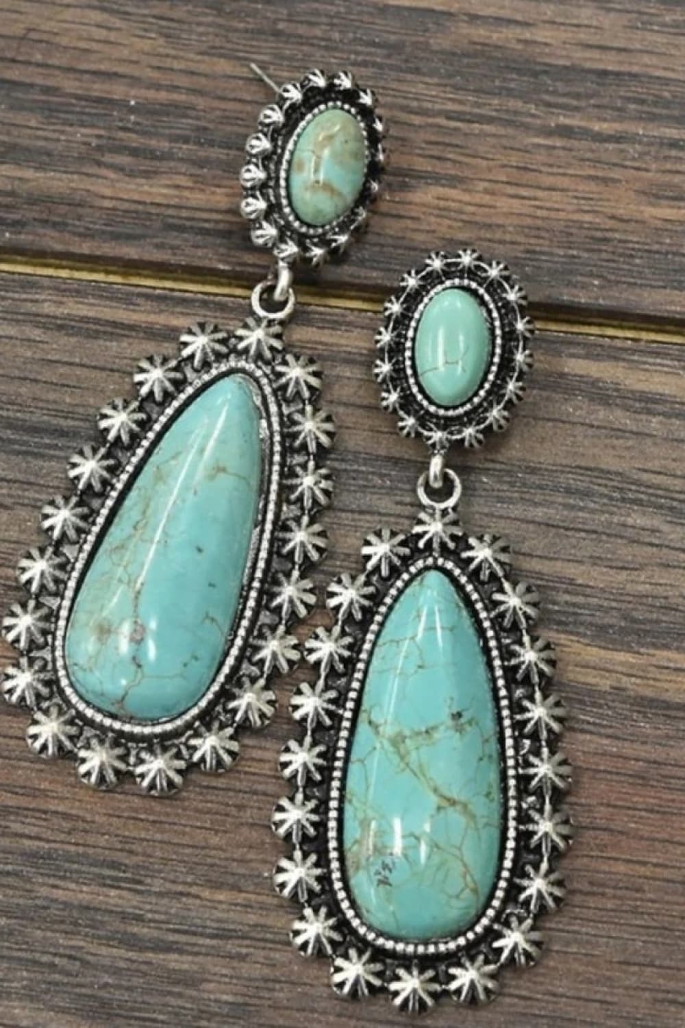 Teal artificial turquoise dangle earrings with ornate silver-tone metalwork.