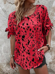 Scarlet Dalmatian print blouse with bow sleeves and a boatneck neckline.