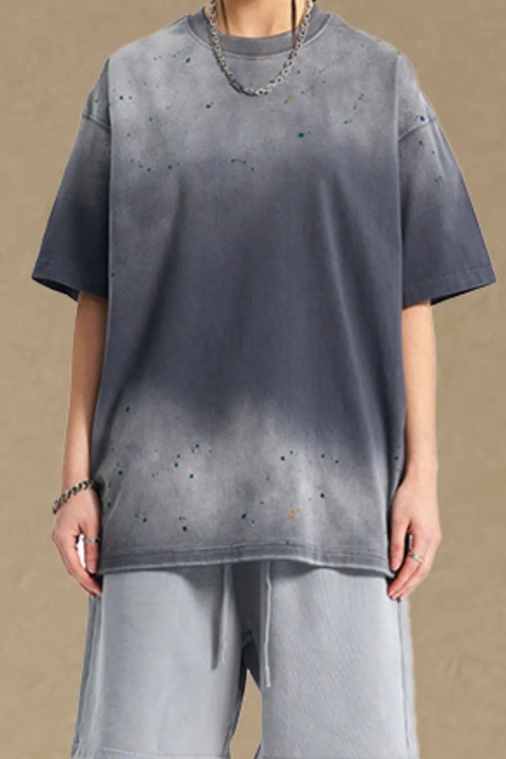 Oversized gray t-shirt with paint splatter detail and crew neck.