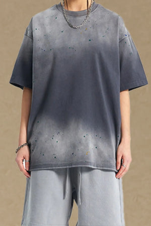 Oversized gray t-shirt with paint splatter detail and crew neck.