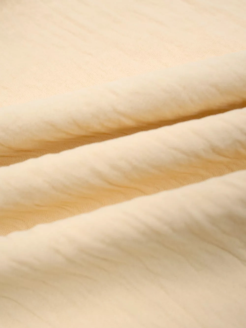 Pastel yellow maternity pants fabric detail with soft texture