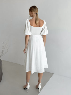 White midi dress with puff sleeves, square neckline, and A-line skirt.