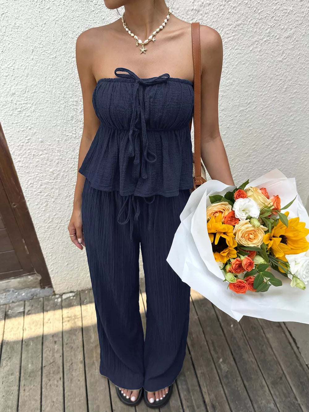 Navy ruffled peplum tube top and drawstring wide-leg pants set