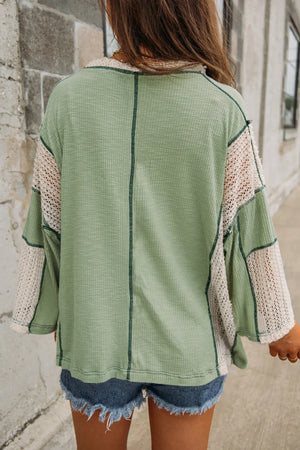 Textured patchwork tunic top in Gum Leaf green with cream crochet sleeves and V-neck.
