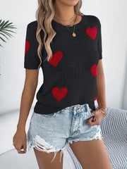 Black knit t-shirt with red heart motif, short sleeves, crew neck, casual style.