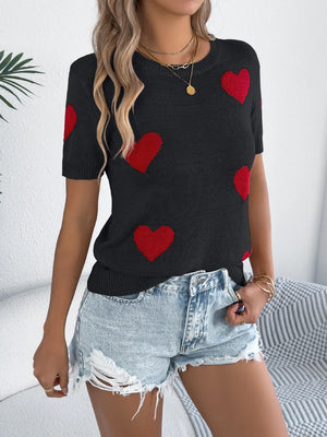 Black knit t-shirt with red heart motif, short sleeves, crew neck, casual style.