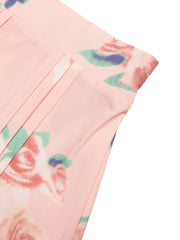 Pink floral print midi skirt with pleated detail and structured shoulder top detail.