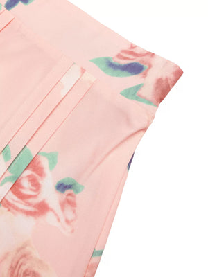 Pink floral print midi skirt with pleated detail and structured shoulder top detail.