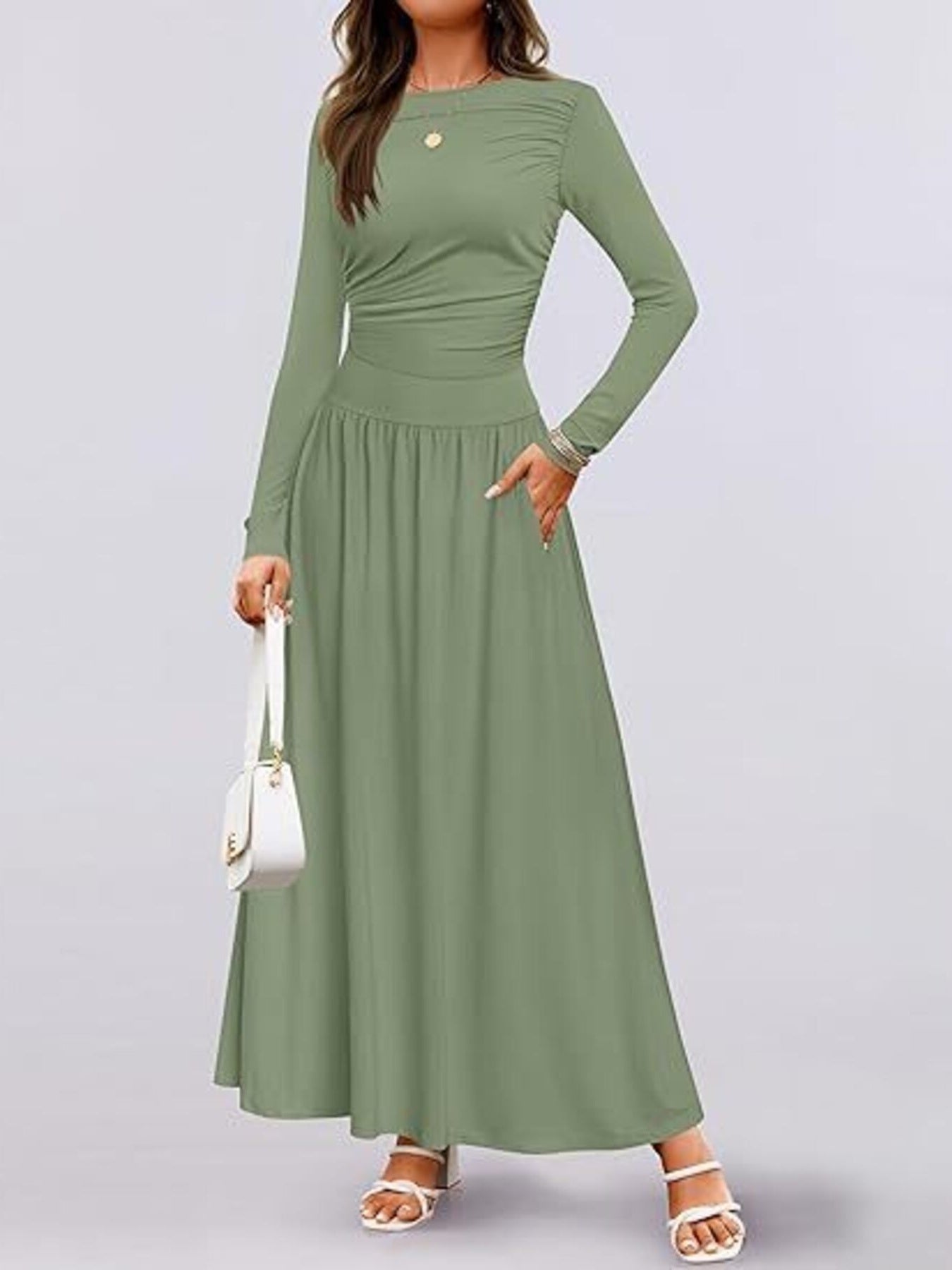 Green ruched long sleeve maxi dress with pockets and a cinched waist.