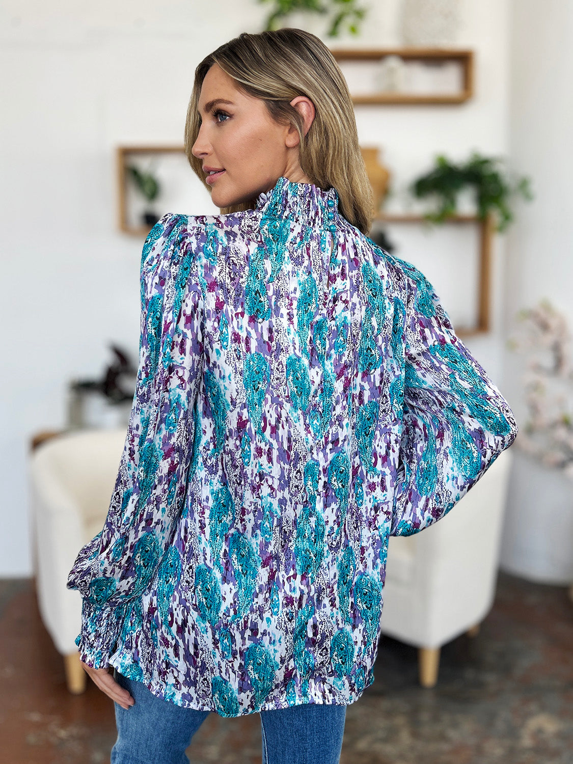 High neck abstract print blouse in blue and purple with long sleeves.