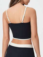 Black contour-trimmed crop top with white trim and adjustable straps