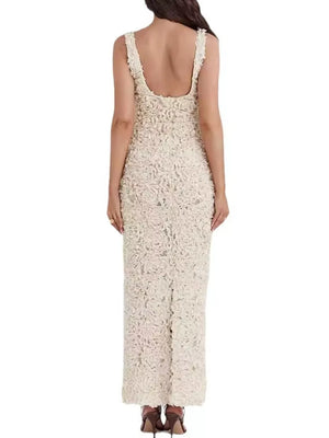 Elegant floral applique maxi dress in cream with a scoop neckline and sleeveless design.