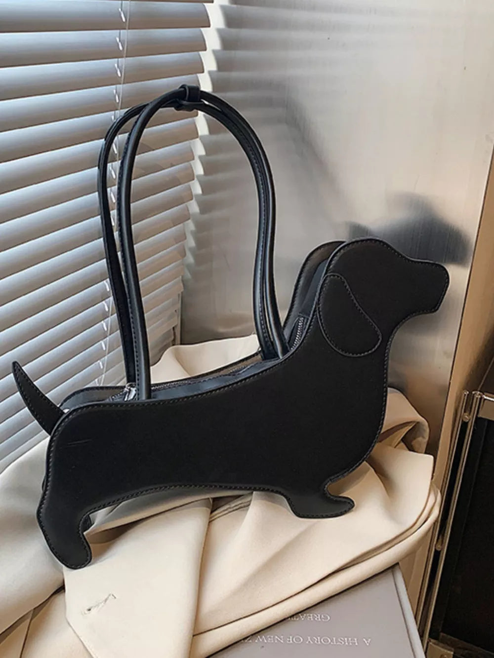 Black PU leather dachshund shoulder bag with top handles and zipper closure.