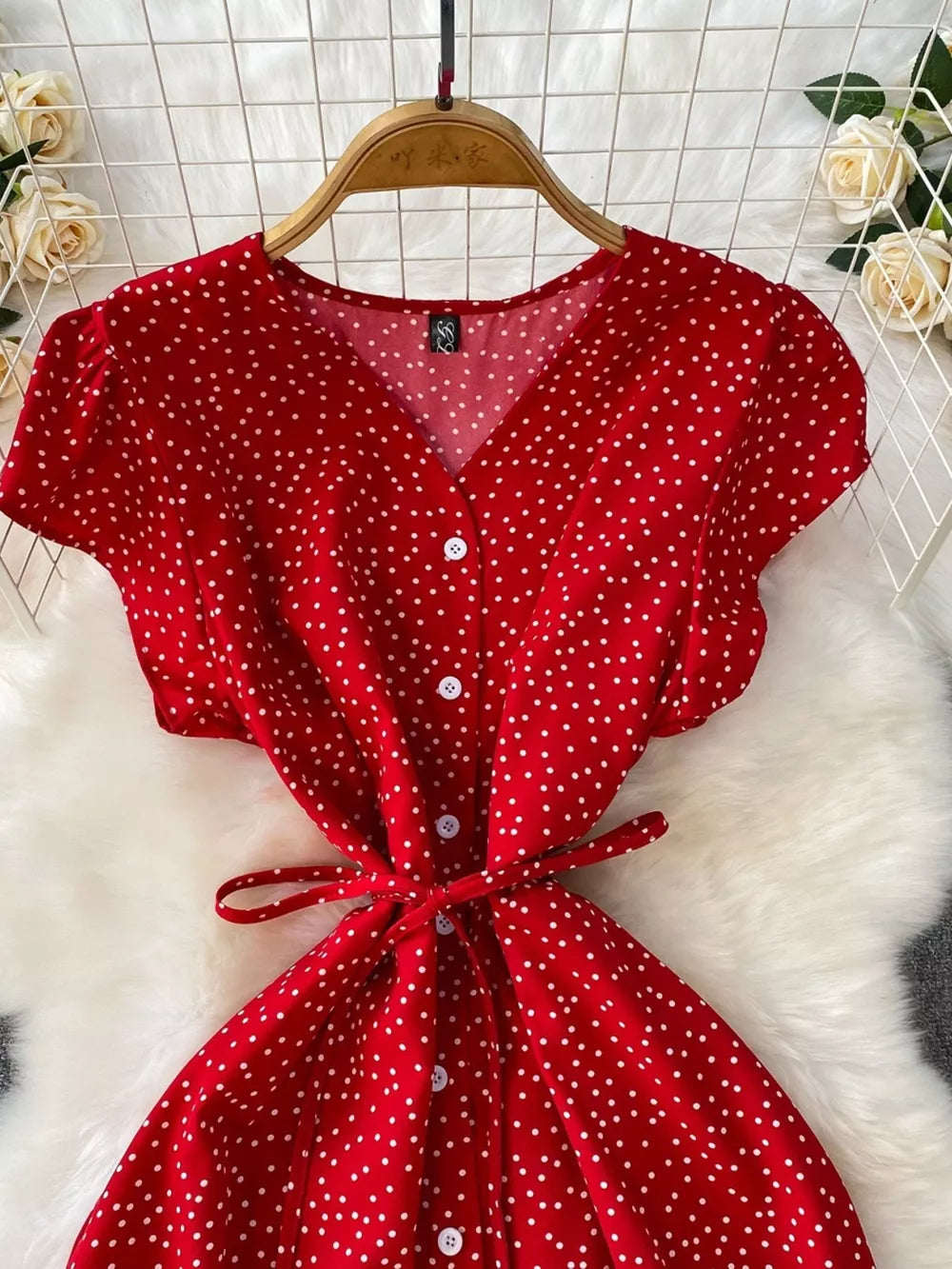 Red polka dot maxi dress with button front and tie belt.