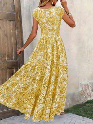Yellow damask print maxi dress with cap sleeves and tiered skirt.