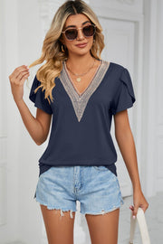 Navy V-neck flutter sleeve blouse with lace trim detail