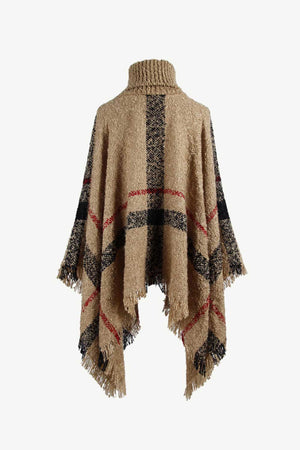Beige plaid turtleneck cape with fringe detail and textured acrylic knit.