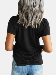 Black raglan t-shirt with short sleeves and a relaxed fit, paired with denim shorts.