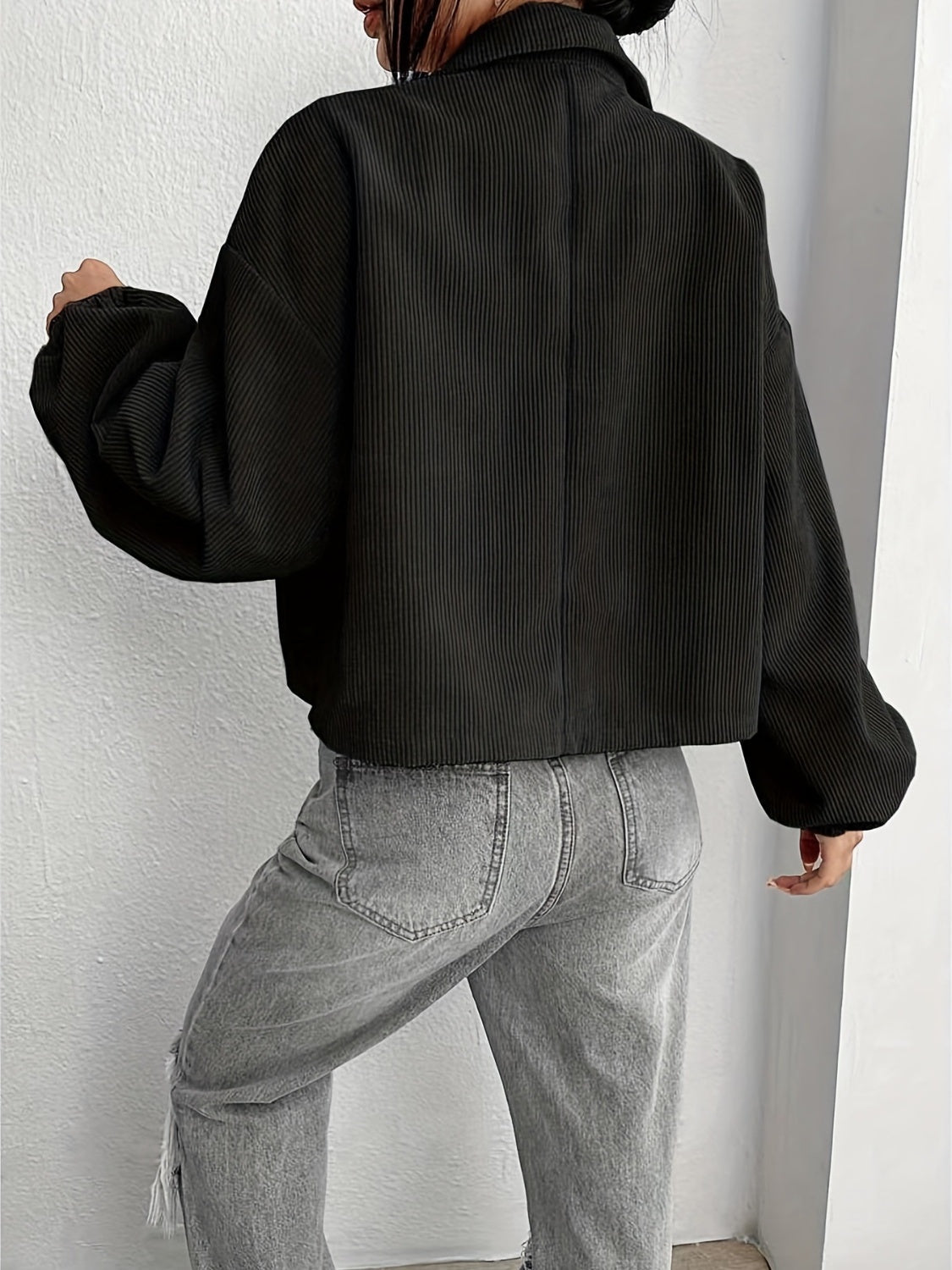 Black corduroy blouson jacket with balloon sleeves and collar, cropped length.