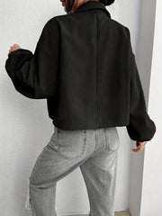 Black corduroy blouson jacket with balloon sleeves and collar, cropped length.