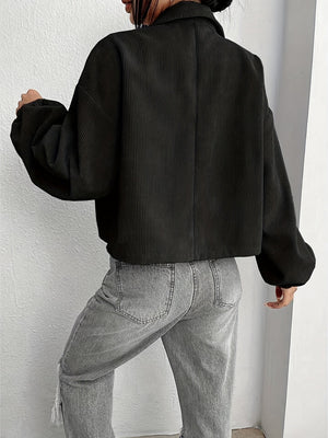 Black corduroy blouson jacket with balloon sleeves and collar, cropped length.