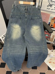 Men's wide-leg jeans in vintage wash denim with distressed details and a relaxed fit.