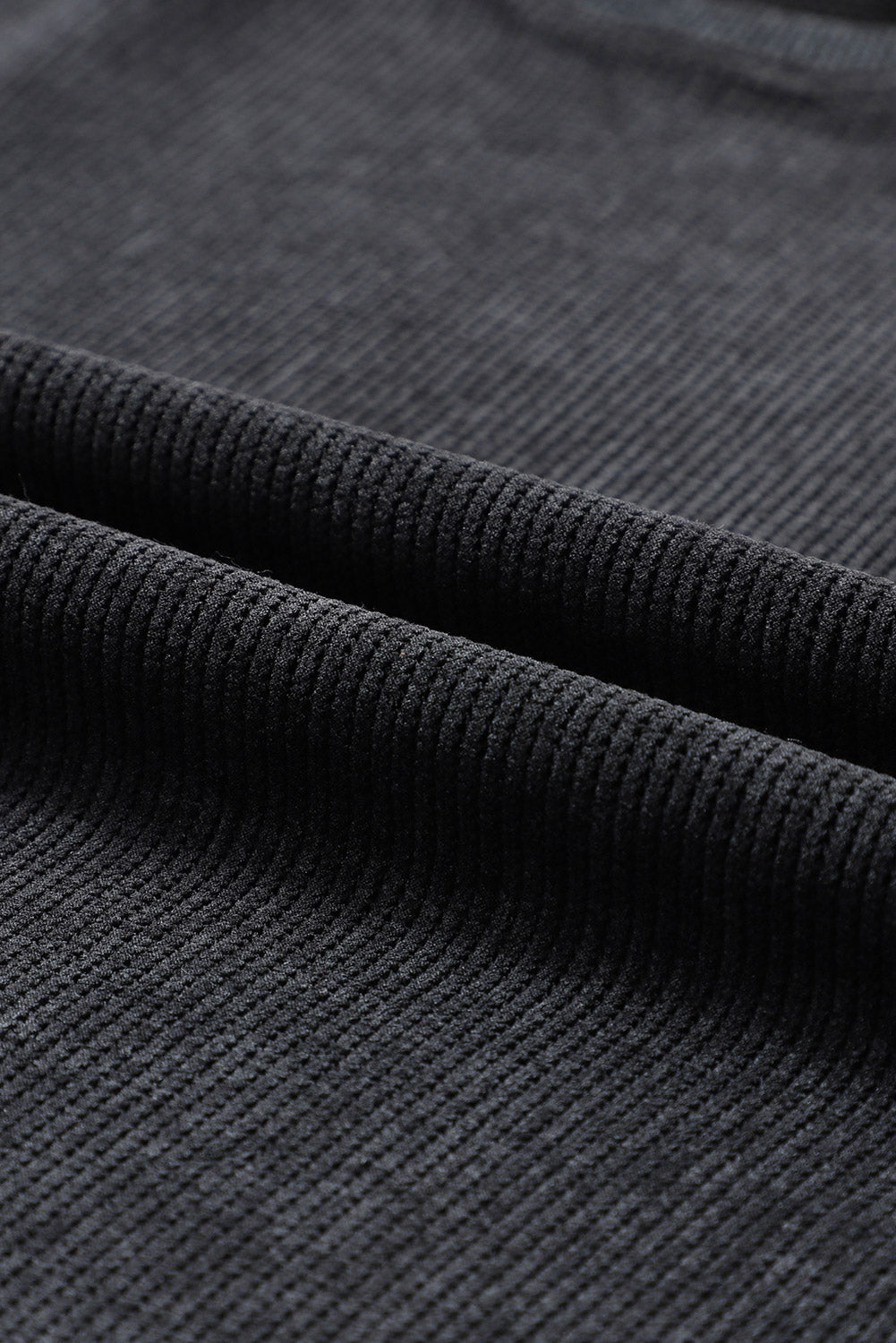Black ribbed knit sweatshirt fabric detail