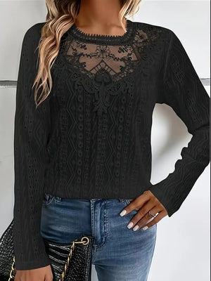 Black lace yoke and eyelet embroidered blouse with long sleeves.