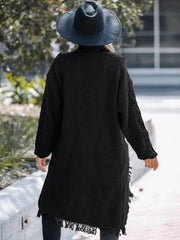 Black acrylic maxi cardigan with textured knit and fringe hem detail.