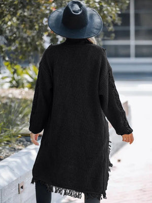 Black acrylic maxi cardigan with textured knit and fringe hem detail.