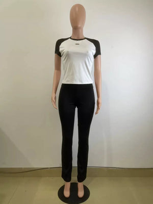 Chic contrast two-piece set: white tee with black sleeves and black pants.