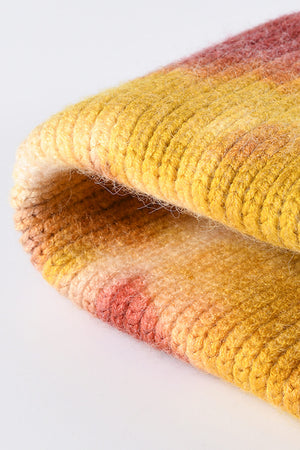 Ribbed knit beanie with a sunset dip-dye pattern in yellow, pink, and orange hues.
