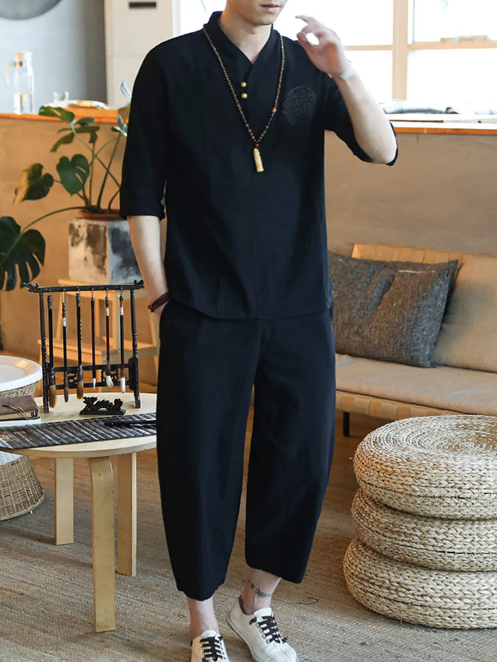 Men's black 3/4 sleeve casual pants set with V-neck shirt and relaxed fit trousers.