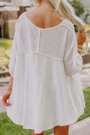 White lace-inset dolman sleeve blouse with a relaxed fit and textured knit detail on the back and sleeves.