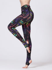 Black stirrup leggings with a colorful palm leaf print and high waist.